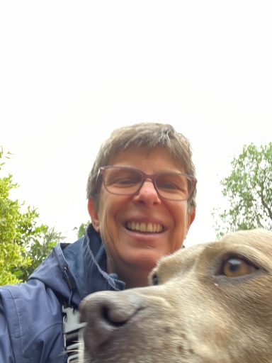 Photograph of Sue the dog trainer and the top of Bella (the dog) who Sue looks after.