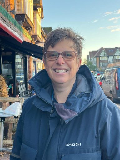 A photograph of Sue the dog trainer outside a shop.